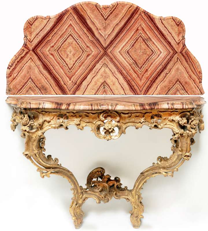 A Roman Rococò Carved Giltwood Console Table, with a serpentine veneered Pavonazzetto Romano marble top